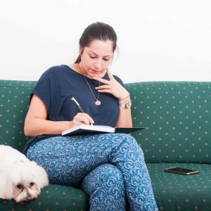 woman dog note taking